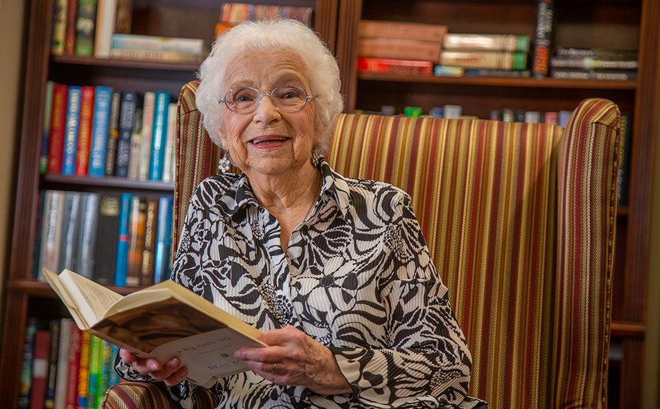 The library at Osprey Heights with shelves of books and comfortable seating