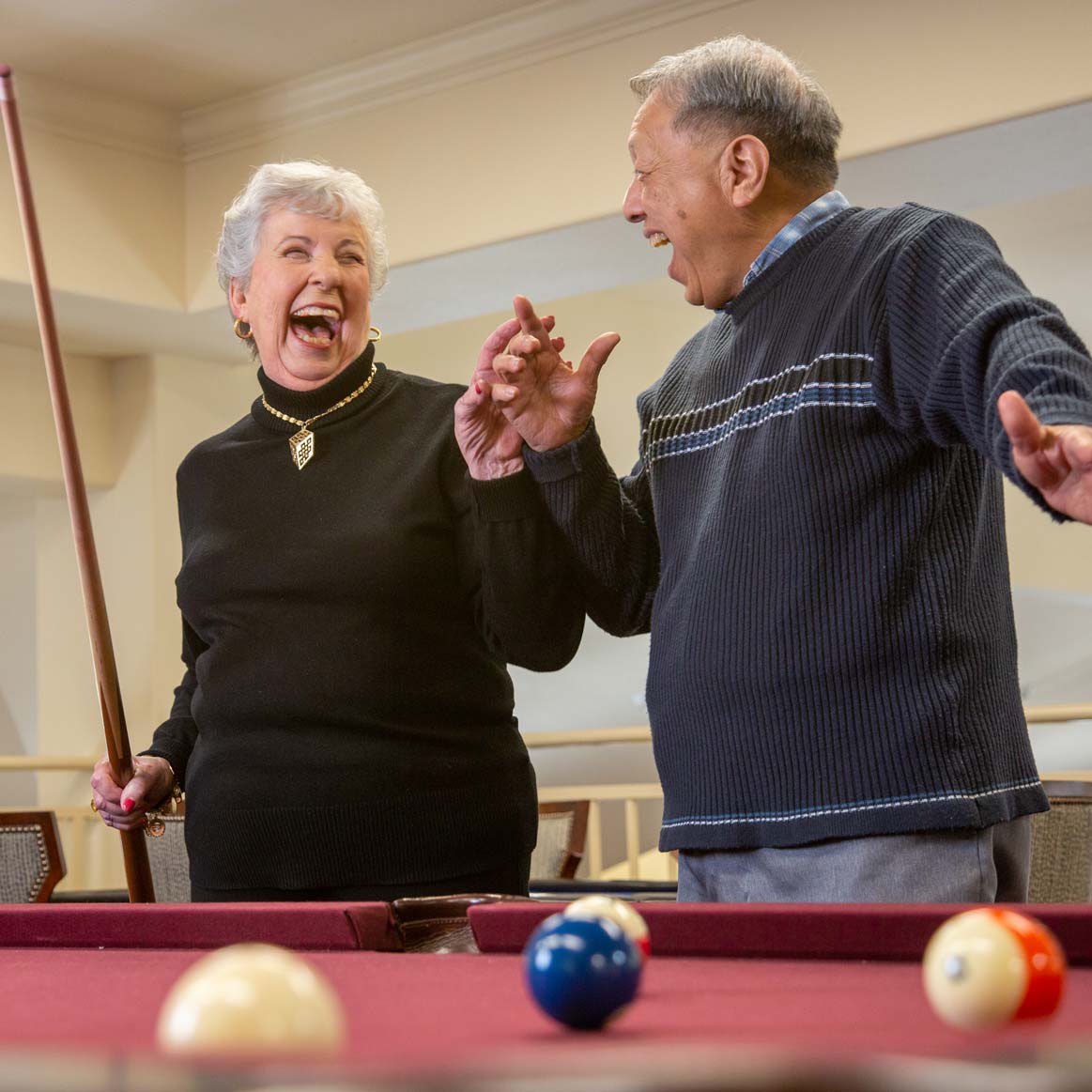 Residents playing billiards at Osprey Heights